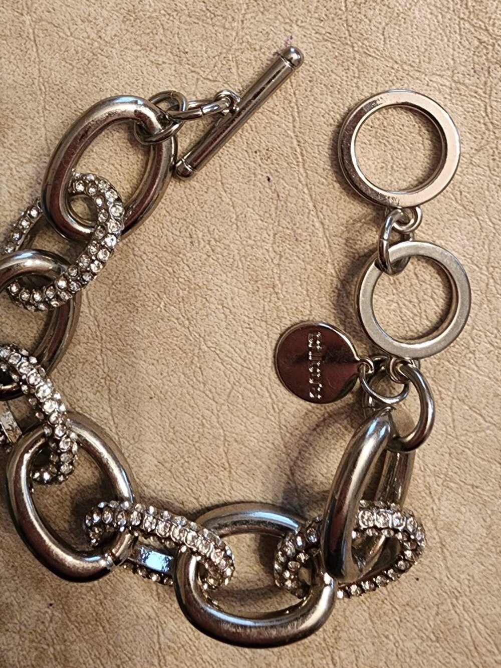 CHICOS SILVER TONE LINK AND PAVE BRACELET WITH TAG-TOGGLE CLASP